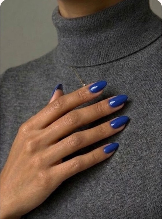 The same hand with glossy royal blue nails.